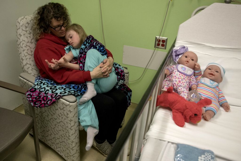 First Place, Feature Picture Story - Jessica Phelps / Newark Advocate, “Living on Love”Leah Hrebluk holds her daughter, Kyndall close before she goes in for surgery at Nationwide Children's Hospital March 10, 2020. Kyndall had been having severe sinus infections, a symptom common for those with Down syndrome. The surgery was to help alleviate those symptoms by removing her tonsils. Kyndall's dolls, Baby Luke and Lucy Lu are on her hospital bed so she will have something familiar when she wakes up from the surgery.